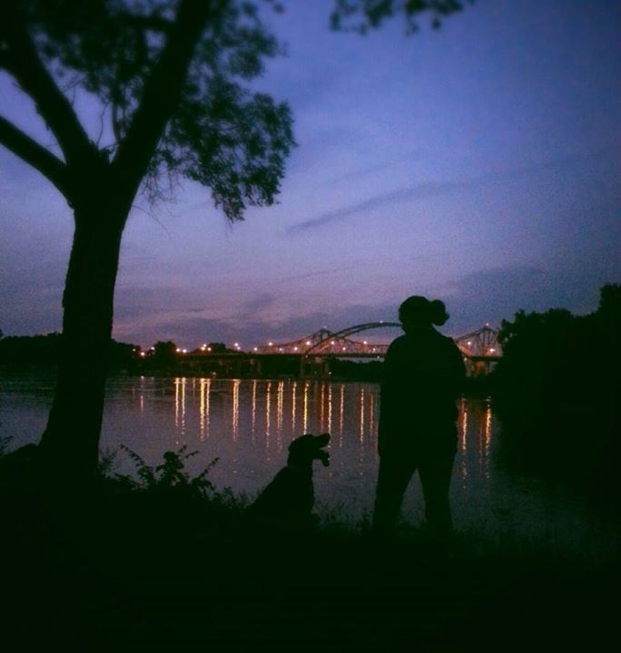 Dog and Owner standing outside at night